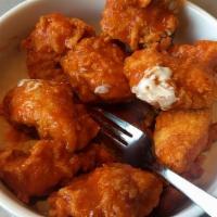 Boneless Chicken Wings · Breaded boneless Chicken Wings naked or tossed in your choice of sauce flavor. Served with y...