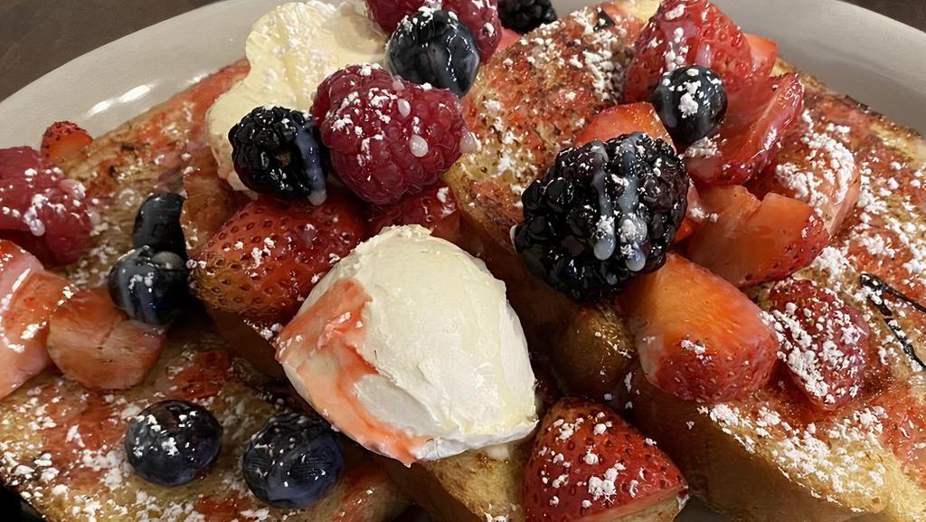 Very Berry French Toast · Three slices of French toast, mixed berries, topped with mascarpone, vanilla glaze, and berry glaze.