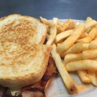 Ham & Bacon Club · Ham, bacon, American cheese, Swiss cheese, lettuce, tomato, and mayo on butter toasted sourd...