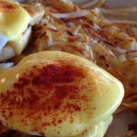 Eggs Benedict · Served with your choice of hash browns, or home fries, or fruit or grits.