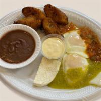 Huevos Divorciados · 2 eggs with green and ranchera salsas served with fried plantains, refried beans, fresh chee...