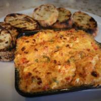 Crawfish Fondue · Bubbly crawfish and cheese dip, served with grilled bread.