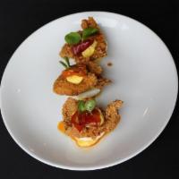 The Chicken Or The Egg · Farm deviled eggs topped with pickled sweet pepper and fried chicken bite