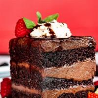 Chocolate Layer Cake · Three layer chocolate mousse cake with, chocolate chantilly cream, berry garnish