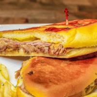 Cuban Sandwich · Double pressed Puerto Rican roast pork and ham. Made with homemade Cuban bread and served wi...