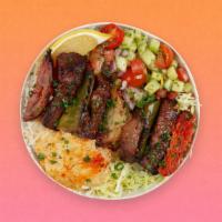 Beef Skewer Rice Bowl · Grilled beef over basmati rice with hummus, diced cucumber and tomato salad, shredded lettuc...