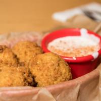 Boudin Balls · Spicy Cajun sausage mixed with rice, hand breaded and deep fried. A Southern favorite served...