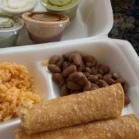 Flautas · Crispy chicken flautas with cheese stuffed in. Served with side of guac, sour cream, rice an...