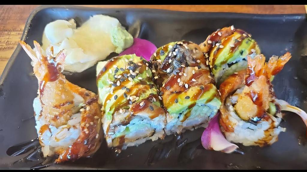 Dragon Roll · Shrimp tempura ,cucumber wrapped with eel and avocado .Drizzled with eel sauce and sesame seeds.
