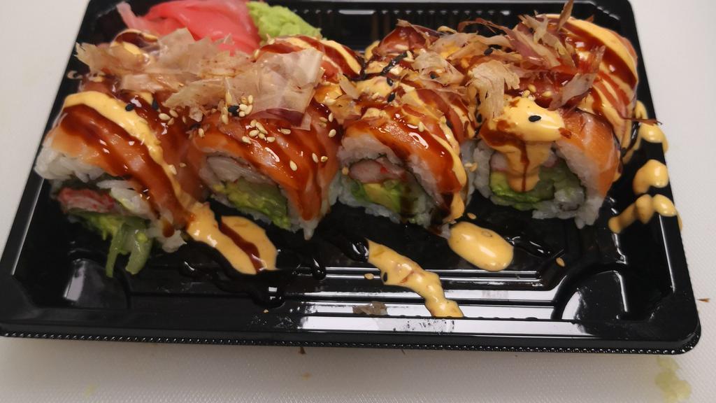 Yammy Yammy Roll · Imitation crab,avocado ,cucumber, wrapped with salmon on top ,Drizzled with eel sauce, spicy mayo, and bonito flakes.