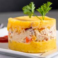 Causa Rellena · Two layers of mashed potatoes and one layer of shredded chicken with mayo and vegetables.