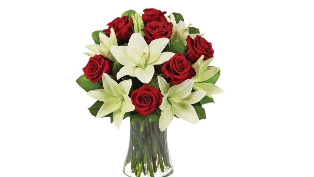 Lily And Rose Bouquet Vase · Beautiful Lily and Rose Arrangement in a glass vase with greenery and filler.