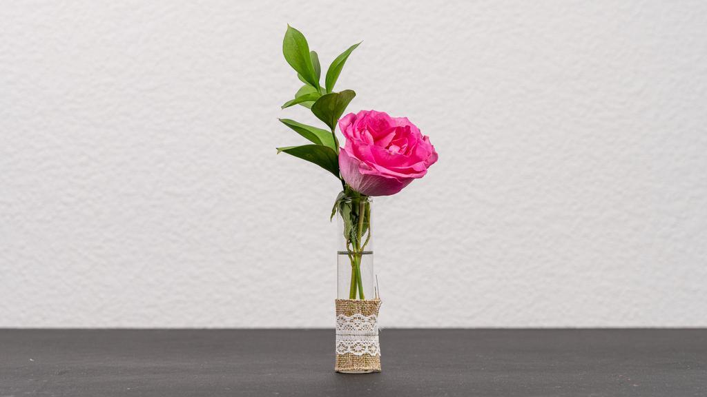 A Shot Of Love Pink Rose · Single Pink Rose in a glass cylinder vial accented with  burlap and lace.

*Vial is 5 inches in height.