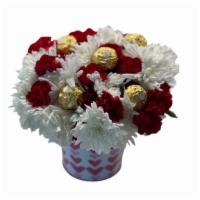 Carnation Surprise W/ Rocher · White and Red Carnation Arrangment in a beautiful pail with Rocher Chocolate on top
*Pail co...