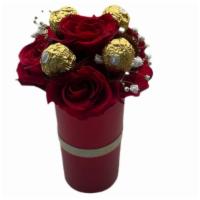 Love Funnel And Rocher  · 5  beautiful red roses in a cylinder shaped planter. Arrangment is composed of 5 beautiful r...