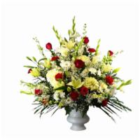 Deluxe Hope Arrangement  · White and Claissic Blooms with acccents of red in a white planter.