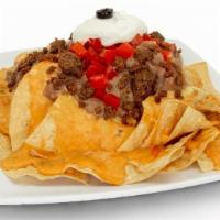 Super Nachos · Choice of ground beef, chicken, carnitas or steak topped with queso, tomatoes, refried beans...