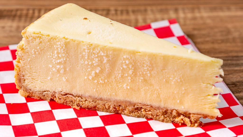 Original Cheesecake · New York! New York! Our Original Cheesecake is a Plain New York Cheesecake made with only the finest of ingredients: Cream Cheese, Pure Vanilla, Sugar, and Whole Eggs. This smooth and creamy cheesecake is sure to become a Crooked favorite!