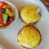 Traditional Eggs Benedict · 2 poached eggs with Canadian bacon atop English muffins with hollandaise sauce served with a...