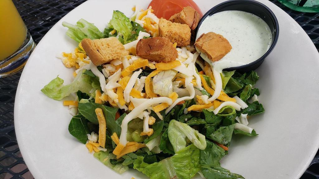 The Garden Salad · Mixed romaine and iceberg lettuce with diced tomatoes shredded cabbage and carrots, croutons and jack & cheddar cheese