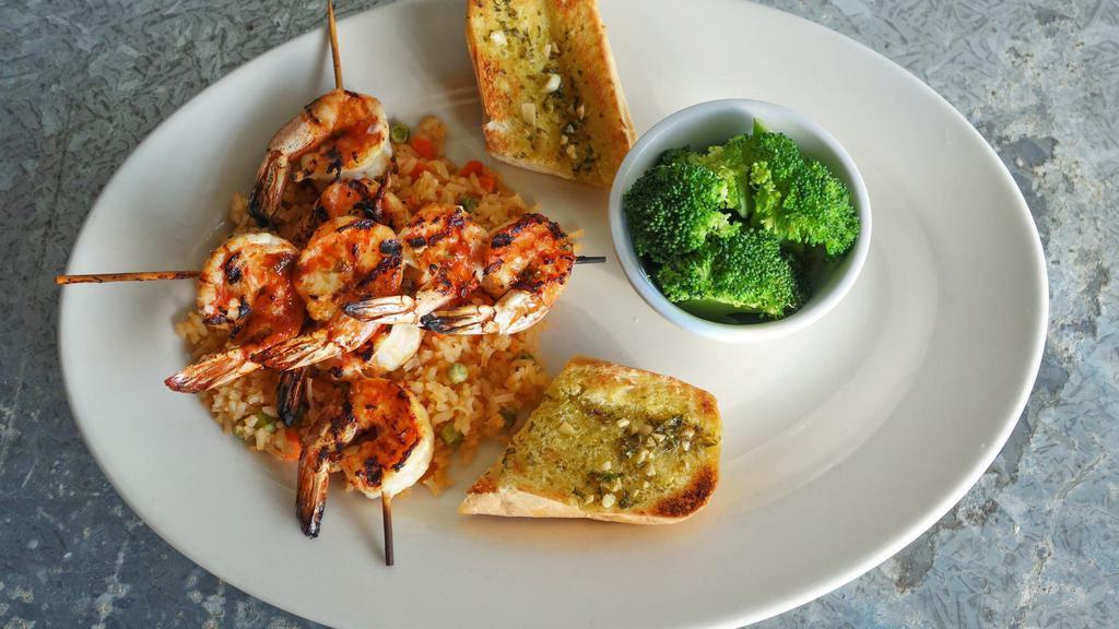 Grilled Shrimp · 1/2 lb. of marinated and grilled jumbo shrimp served on a bed of Spanish rice with garlic bread and two sides.