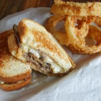 Blackened Steak Sandwich · Sliced blackened steak topped with sautéed mushrooms, onions and Swiss cheese served on Fren...