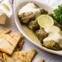 Dolmathes · Fresh grape leaves stuffed with rice, Ground beef and spices, served with grilled pita bread.