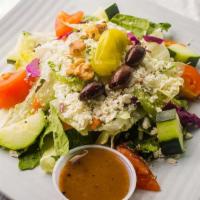 Greek Salad · Romaine and iceberg lettuces with fresh tomatoes, cucumbers, feta cheese, walnuts, kalamata ...
