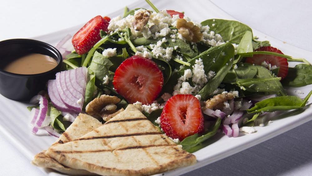 Spinach Salad · Baby spinach, fresh orange slices, red onions, crumbled feta cheese, and walnuts tossed with balsamic vinaigrette.
