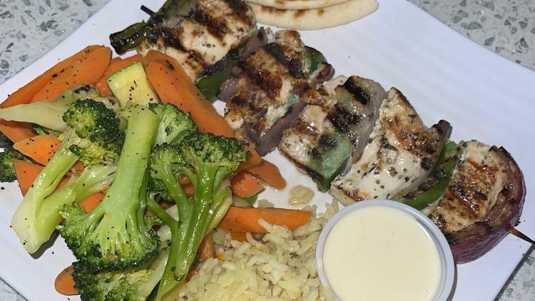 Grilled  Souvlaki · Your choice of protein marinated overnight in our signature recipe then skewered with onions and peppers and grilled- served with sauteed vegetables and grilled pita bread.
