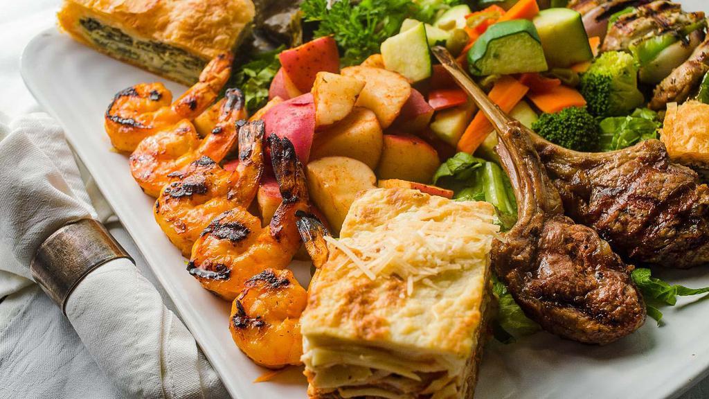 Stratos Specialty Platter · Grilled lamb chops, shrimp scampi, pork souvlaki, moussaka, spanakopita, pastitsio, and dolmathes. Served with roasted Greek potatoes, sauteed vegetables, and pita bread.