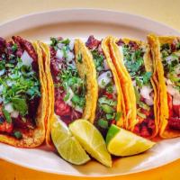 Tacos · Corn tortilla, one choice of meat topped with onion and cilantro.
