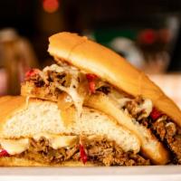 Philly Cheesesteak · Shaved ribeye with grilled onions, red peppers, and topped with melted monterey jack.
