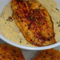 Fish N Grits · A southern classic consisting of a fish fillet served over creamy cheese grits and garlic br...