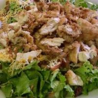 Chicken Fried Chicken Salad · Hand breaded chicken tenders served on fresh greens topped with diced tomatoes, bacon and gr...