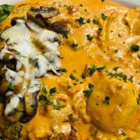 Veal Verona · Breaded veal cutlet sautéed in sun dried tomato cream sauce with mushrooms, mozzarella and c...