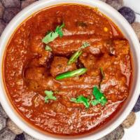 Lamb Curry · Onion base slowly cooked and traditional spices.... comes with a small order of rice on side.