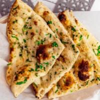 Garlic Naan · (Top Seller) naan covered in a layer of homemade garlic cream, topped with fresh cilantro.