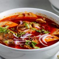 Bún Bò Hu · Spicy Vietnamese beef noodle soup served with beef flank, pork knuckle, and Vietnamese pork ...