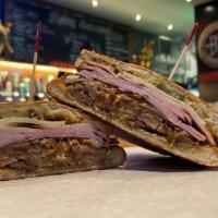 The Cuban · Slow cooked pork, vintage ham, stone-ground mustard, and pickles on Cuban bread.