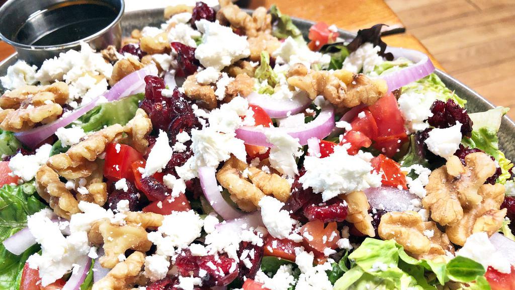 Lauren'S Goat Cheese Salad · Mixed Greens topped with Cranberries, Goat Cheese, Tomatoes, Walnuts, and Red Onions. Served with Balsamic Vinaigrette.