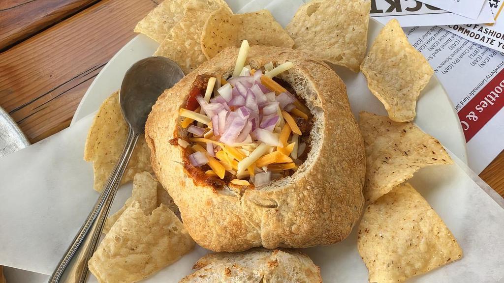 Bowl Of Chili · Served in a bread bowl with cheddar jack cheese, diced red onion, and tortilla chips.