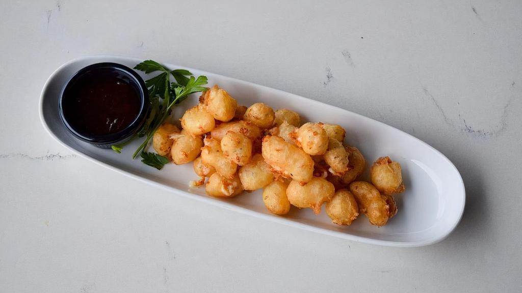 Beer Battered Cheese Curds · Crispy fried cheese curds, coated in tempura beer batter. Served with sweet jalapeño jam.