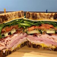 The Club Sandwich · Ham, turkey, bacon, green leaf lettuce, tomato and cheese.