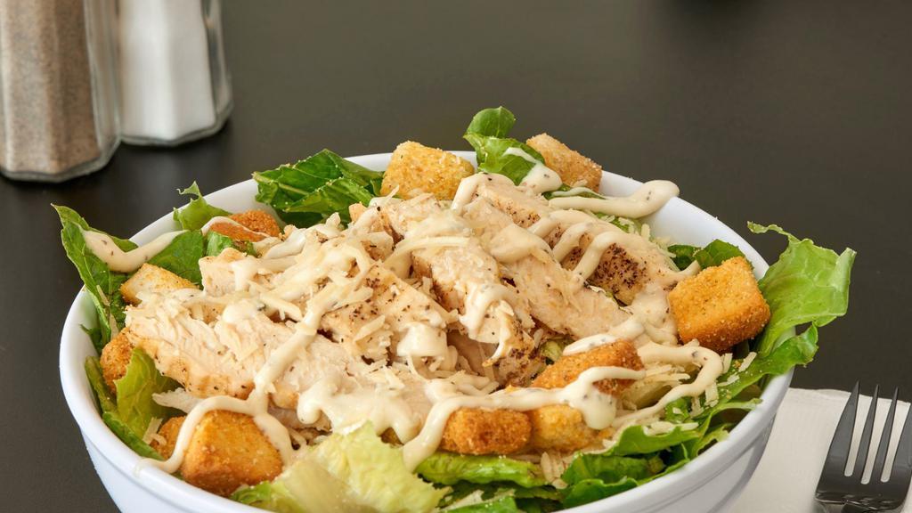 Chicken Caesar Salad · Chicken breast, Parmesan cheese, croutons and romaine lettuce served with peppery Parmesan Caesar dressing.