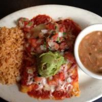Beef Fajita Enchiladas · Beef fajita enchiladas, topped with tex-mex chili meat sauce and cheese, served with sour cr...