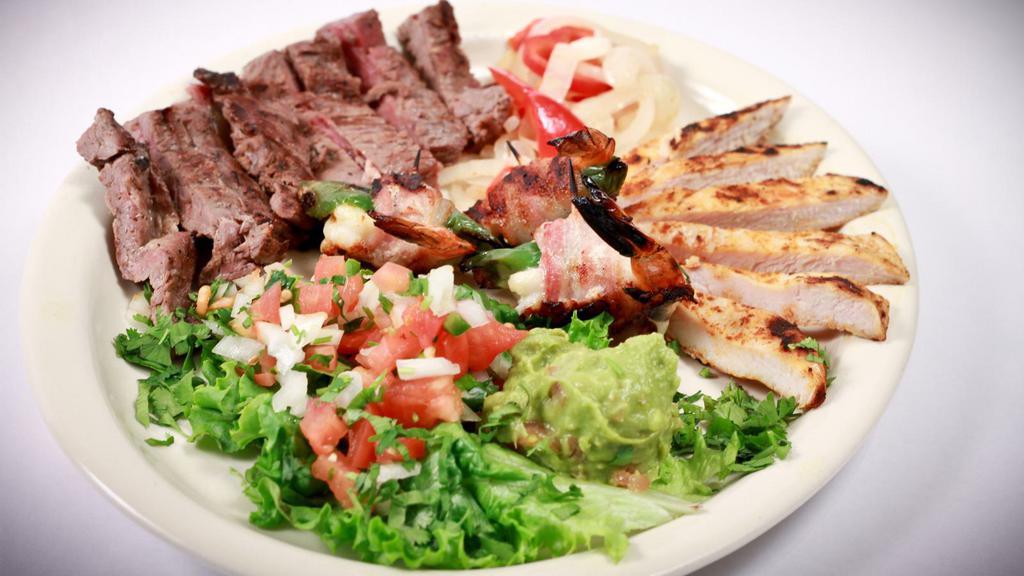 Mixed Grill · Beef, Chicken & Shrimp with Grilled Peppers & Onions, Guacamole, Sour Cream, Pico De Gallo, Cheese & Lettuce Served With Rice & Your Choice Of Beans Choice of corn or flour tortillas.