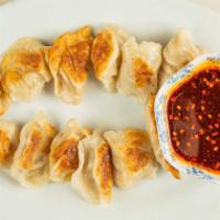 Dumpling (12 Pc)(A2) · Dumplings filled with pork, cabbage,and ginger. Served with spicy dipping sauce.