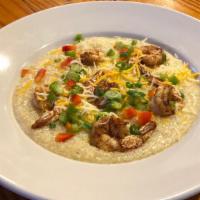Shrimp And Grits · Grits served with jumbo shrimp in cheezy cajun buttery sauce.