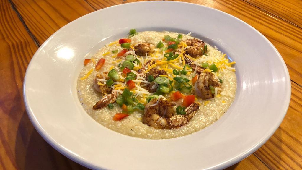 Shrimp And Grits · Grits served with jumbo shrimp in cheezy cajun buttery sauce.